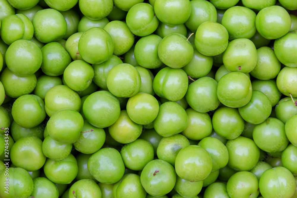 Freshly harvested green cherry plum Freshly harvested green cherry plum