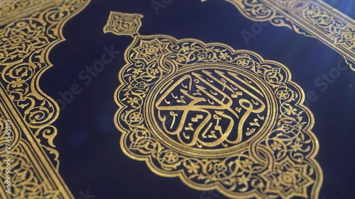 Quran blue cover decorated with gold,with lens flare, shallow depth of field close-up slow tilt down CGI shot.