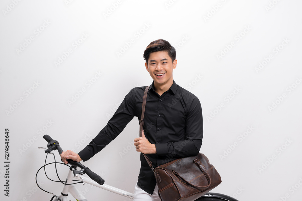 handsome young man with shoulder bag and bicycle standing isolated on white background handsome young man with shoulder bag and bicycle standing isolated on white background