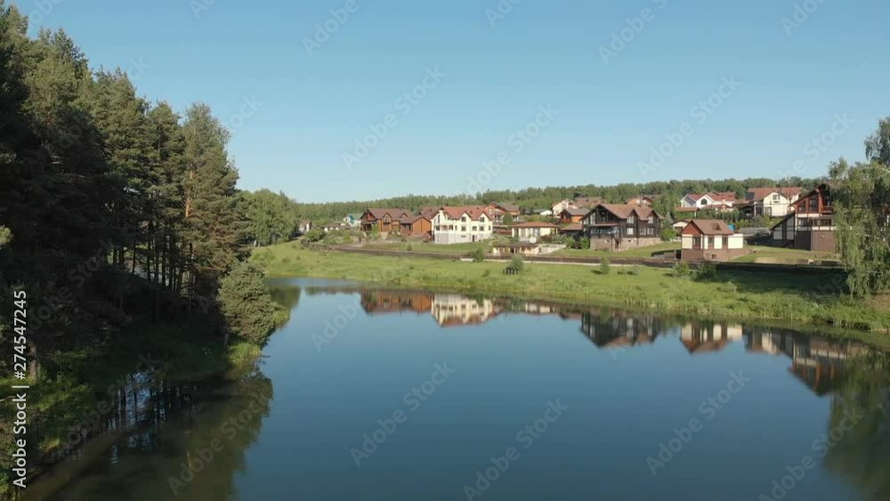 View of the country village. Flying drone above the pond. Video without color correction 4K View of the country village. Flying drone above the pond. Video without color correction 4K