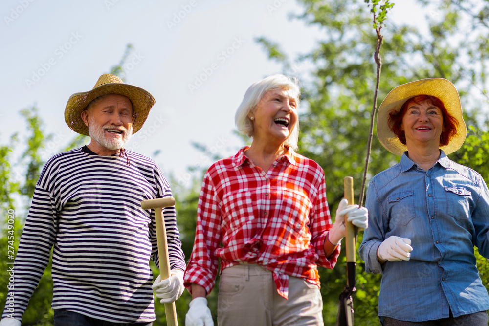 Cheerful and positive man and women heading to plant trees