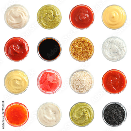 Set of different delicious sauces on white background, top view