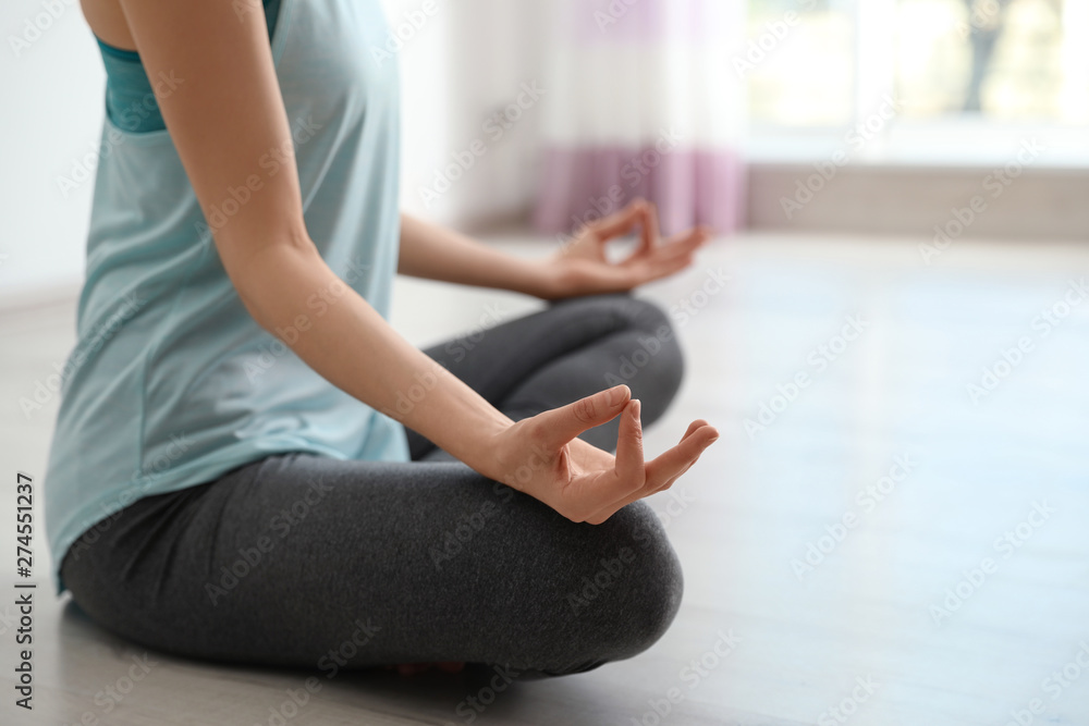Young woman meditating indoors, closeup with space for text. Zen concept