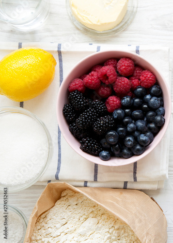 Raw ingredients: berries, lemon, flour, sugar, salt, water for cooking berry pie, top view. From above, overhead, flat lay. Close-up. photo