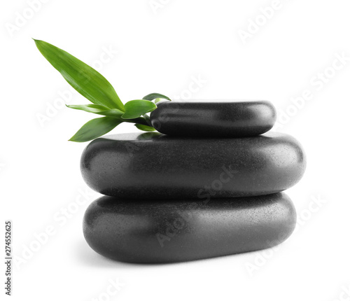 Black spa stones with bamboo isolated on white