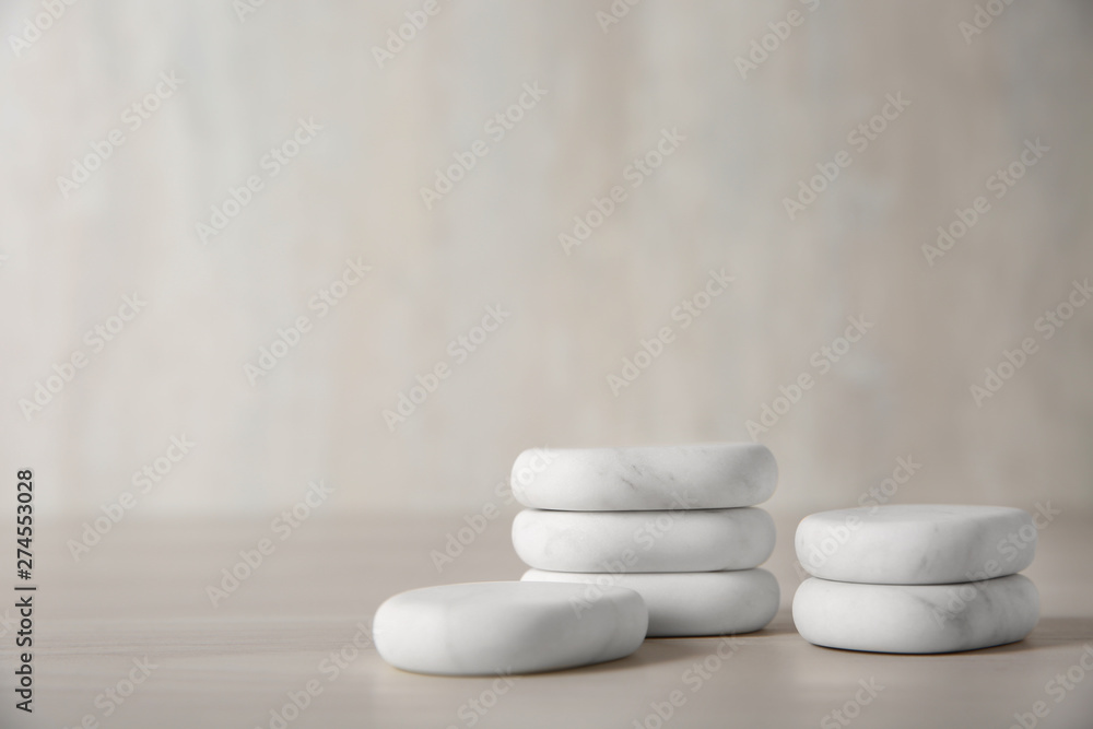 Marble spa stones on light background. Space for text Marble spa stones on light background. Space for text