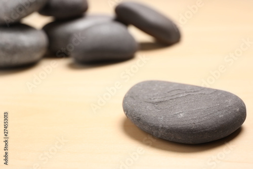 Spa stones on wooden background. Space for text