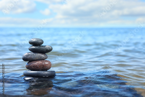 Stack of stones in sea water  space for text. Zen concept