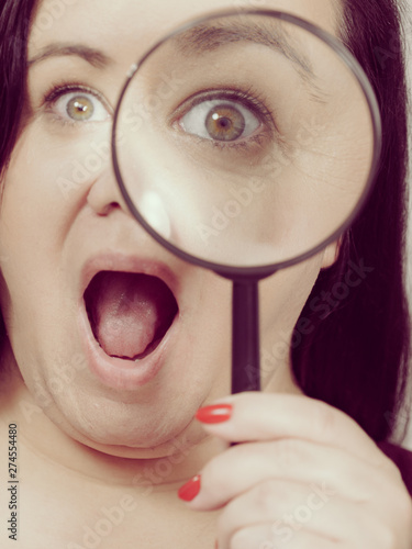 Adult woman with magnifying glss