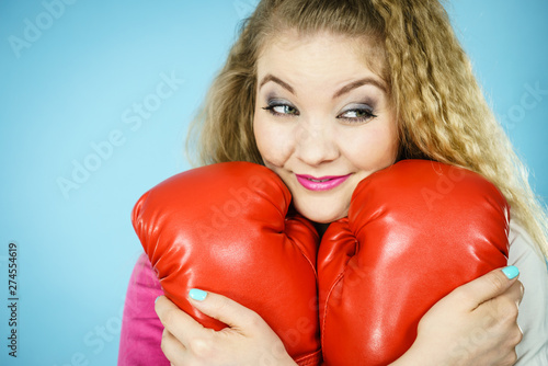Funny girl with red gloves playing sports boxing © Voyagerix