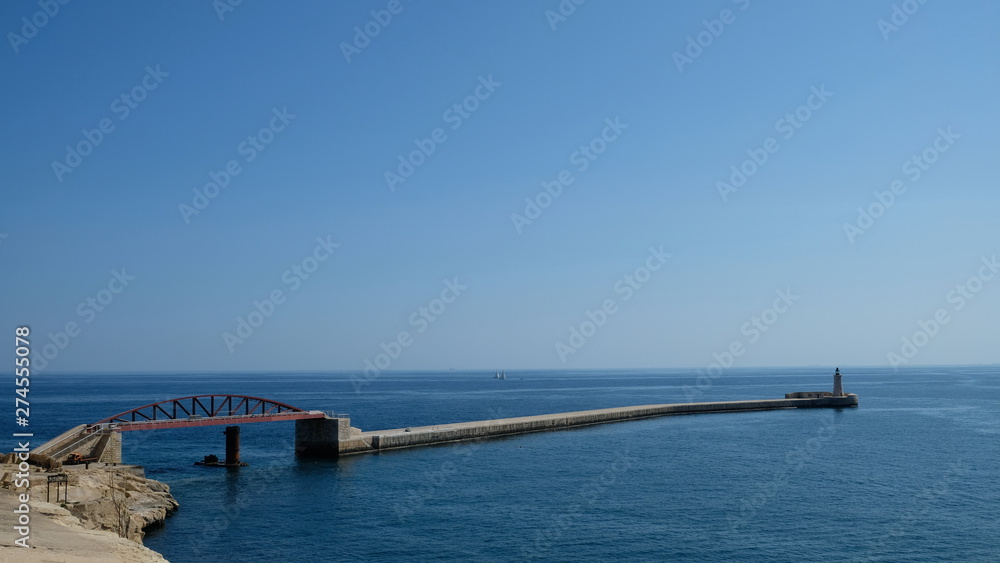 Valleta, capital city of Malta. On a sunny and very hot morning, view of St Elmo Bridge and it´s connection to St Elmo Lighthouse. Valleta, capital city of Malta. On a sunny and very hot morning, view of St Elmo Bridge and it´s connection to St Elmo Lighthouse.