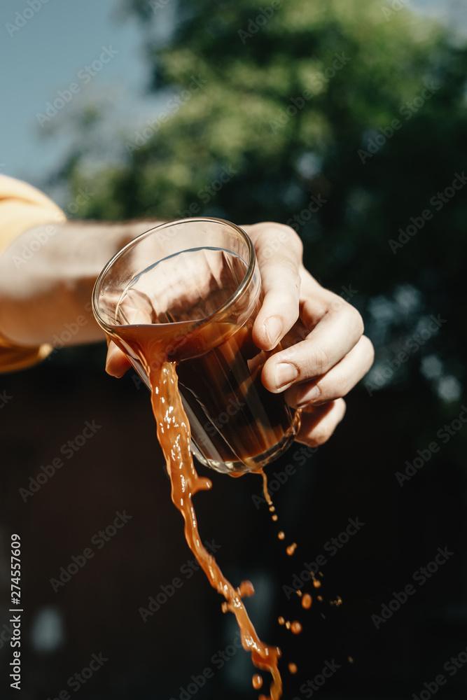 man pouring out glass of coffee