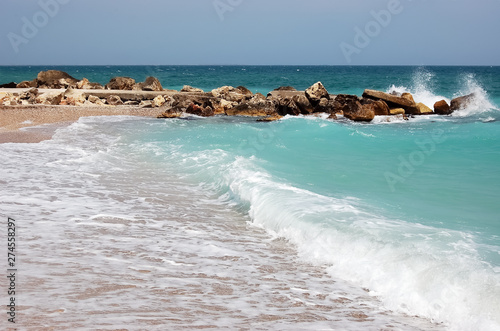 Landscape with waves and turquoise sea on the beach of the Romanian resort.