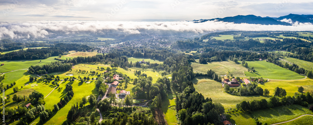 Aerial Bad Toelz Bavarian Alps. Golf Course. Blomberg Mountain. Morning Drone Shot with some clouds in the sky