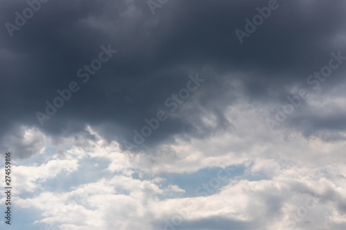 Grey clouds against a grey sky. © lms_lms