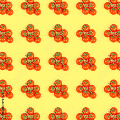 Pattern red tomatoes on a green branch on a yellow background