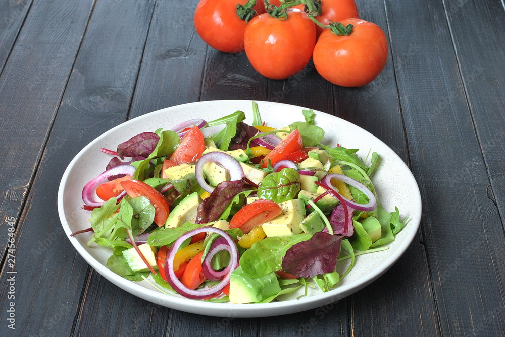 Avocado salad with shrimps, cherry tomatoes, arugula beet leaves, red onion, yellow sweet pepper. Healthy lunch plate with vegetables shrimps Avocado salad with shrimps, cherry tomatoes, arugula beet leaves, red onion, yellow sweet pepper. Healthy lunch plate with vegetables shrimps