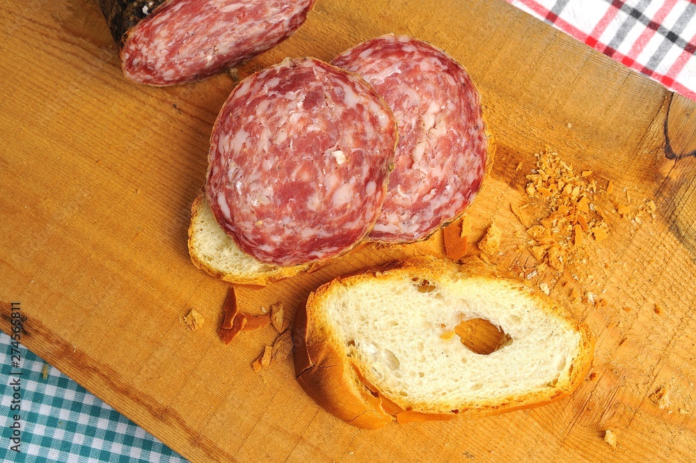 typical traditional Italian salami with bread and suppressed for a snack with healthy food typical traditional Italian salami with bread and suppressed for a snack with healthy food