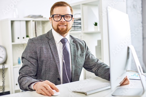 Mid age businessman working on computer at the office