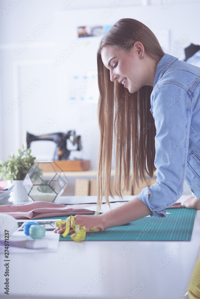 Woman American fashion designer working in atelier. Woman American fashion designer working in atelier.