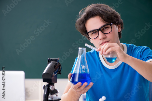 Young male student in the classroom 