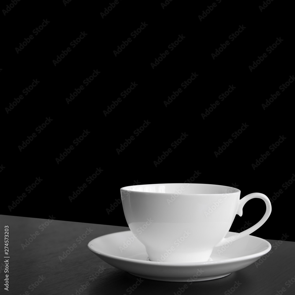 empty white cup for hot coffee or tea and cocoa drink on black or dark wood table for wake up or breakfast in morning and freshness to work office on black background isolated included clipping path empty white cup for hot coffee or tea and cocoa drink on black or dark wood table for wake up or breakfast in morning and freshness to work office on black background isolated included clipping path