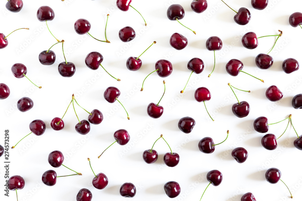Cherry pattern. Ripe cherry berries on white background. Flat lay, top view, copy space Cherry pattern. Ripe cherry berries on white background. Flat lay, top view, copy space