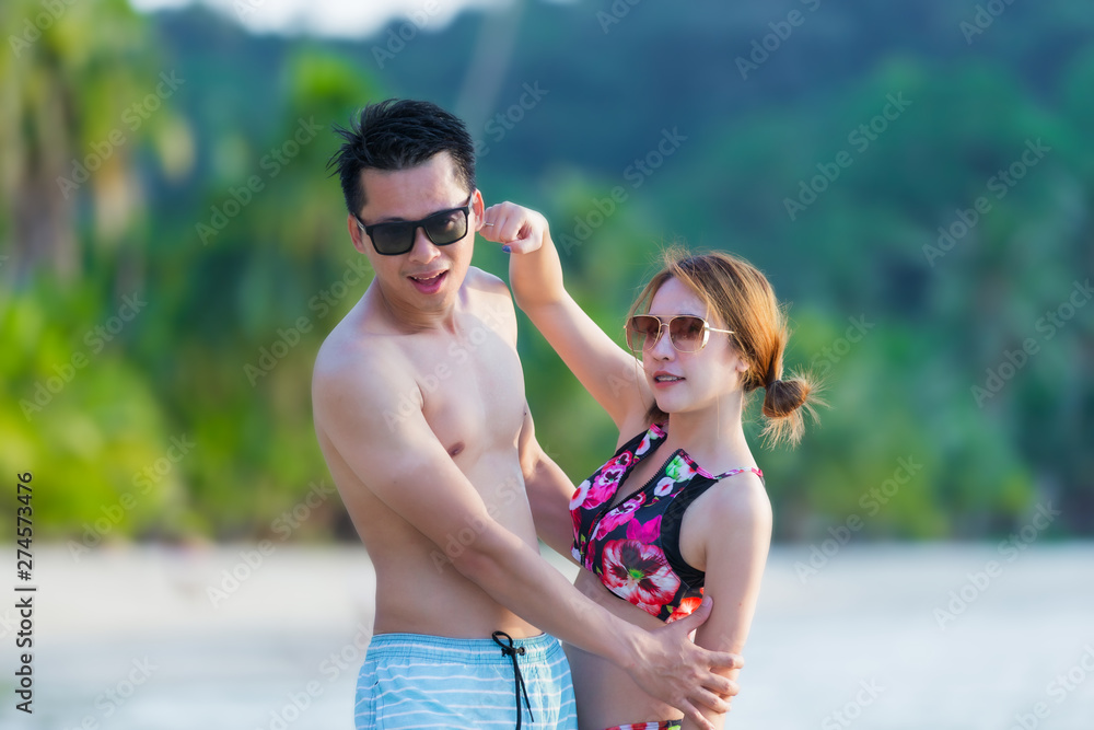 Woman and man , couple lover playing on the beach at tropical sea with they honeymoon vacation. Woman and man , couple lover playing on the beach at tropical sea with they honeymoon vacation.
