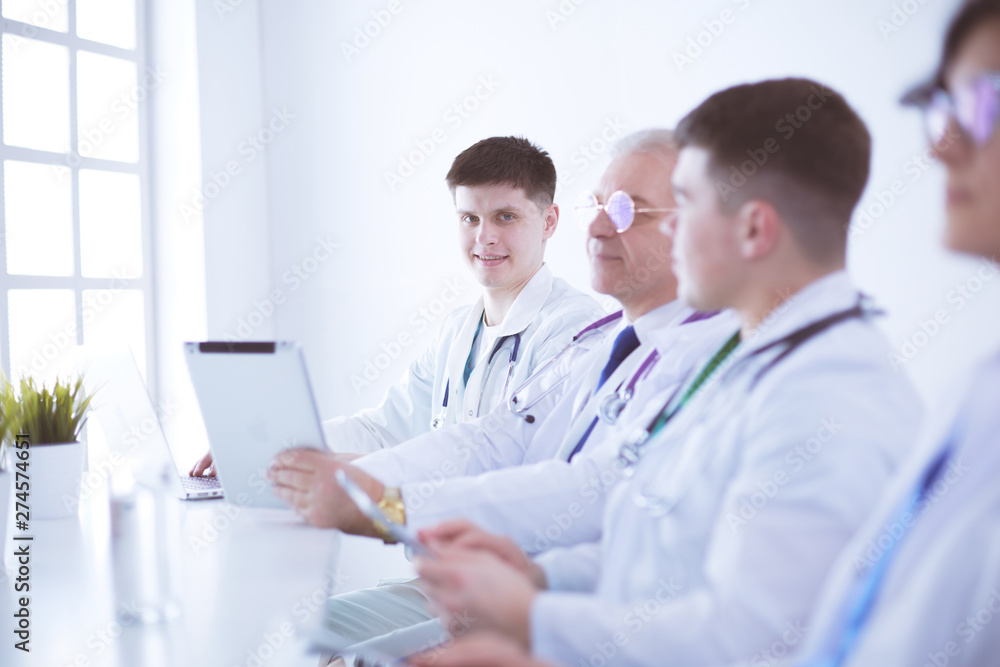 Medical team sitting and discussing at table Medical team sitting and discussing at table