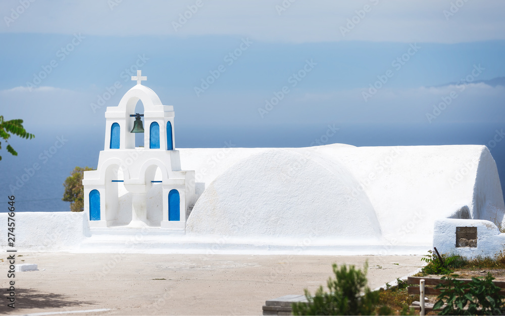 Greek islands style bell tower of church at Oia village, Santorini, Greece