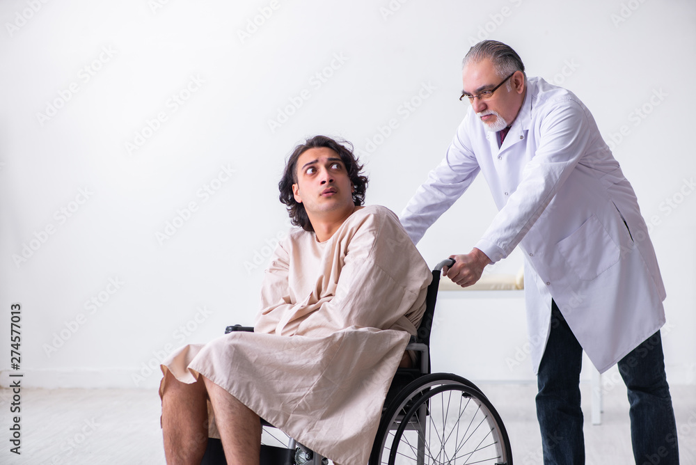 Old male doctor psychiatrist and patient in wheel-chair Old male doctor psychiatrist and patient in wheel-chair