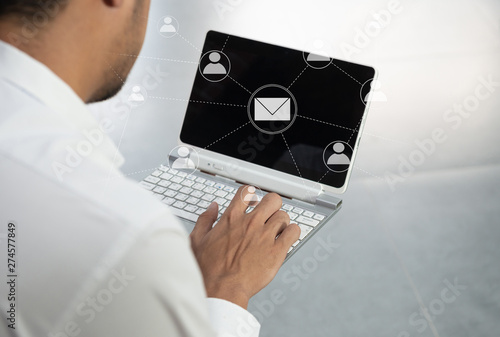Business man is using the laptop with mail and person icon for mailing transfer concept