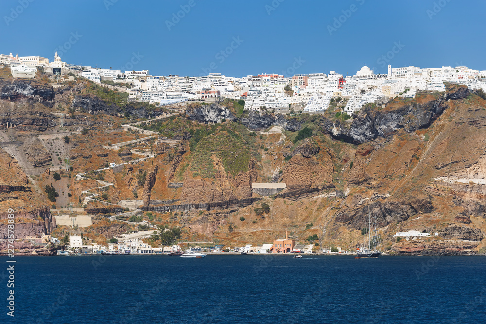 Panoramic unique view along the caldera of Santorini with Fira and Firostefani in the afternoon light, Greece