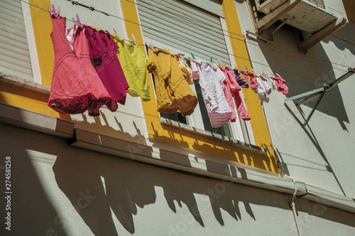 Clothes hanging on window drying in a colorful house