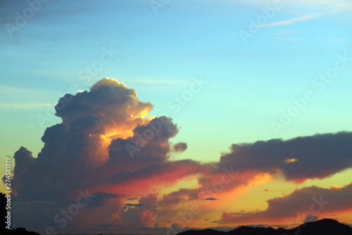 sunset on sea and colorful flame cloud cold sky silhouette island