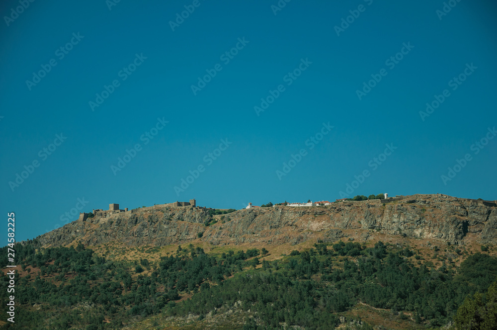Marvao village on top of tall crag with stone walls and towers