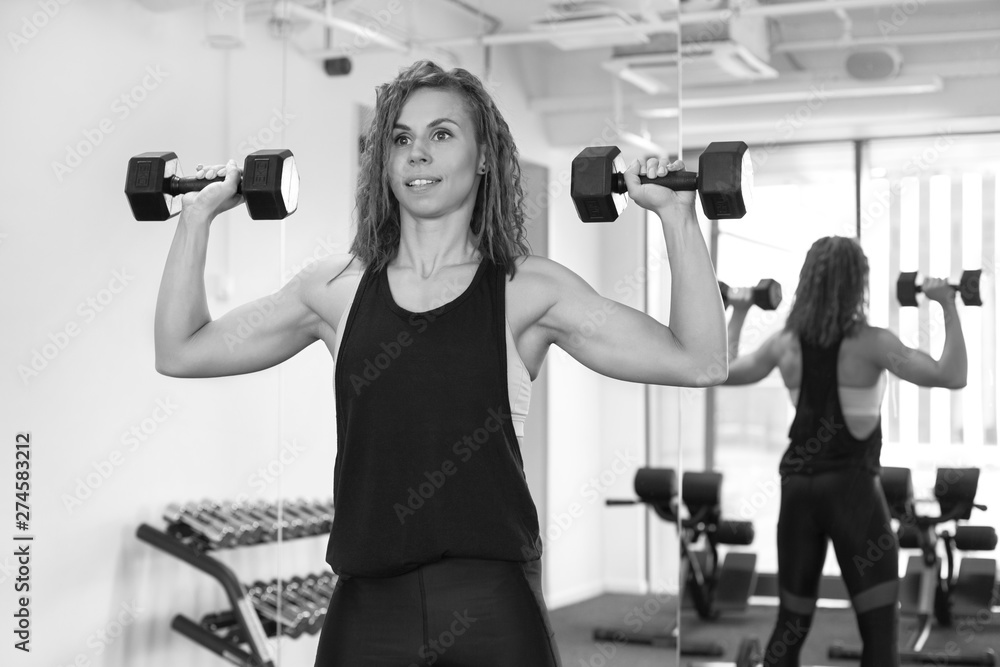 athletic girl trains in a fitness gym athletic girl trains in a fitness gym