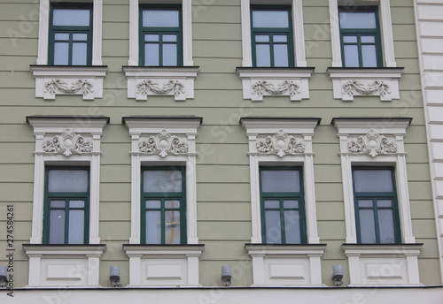 Old historical building facade of classic european house with windows in Moscow, Russia. Russian city typical architecture, close up view of building front facing the street