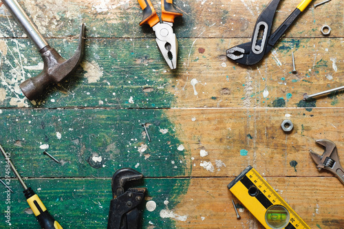 Canvas Print Flat lay set of vintage carpentry tools on colorful wooden background