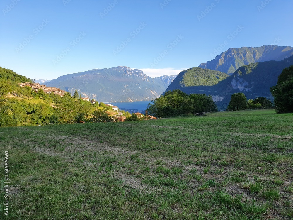 View of the Lake Garda a nearby mountain, Italy.Panorama of the gorgeous Garda lake surrounded by mountains