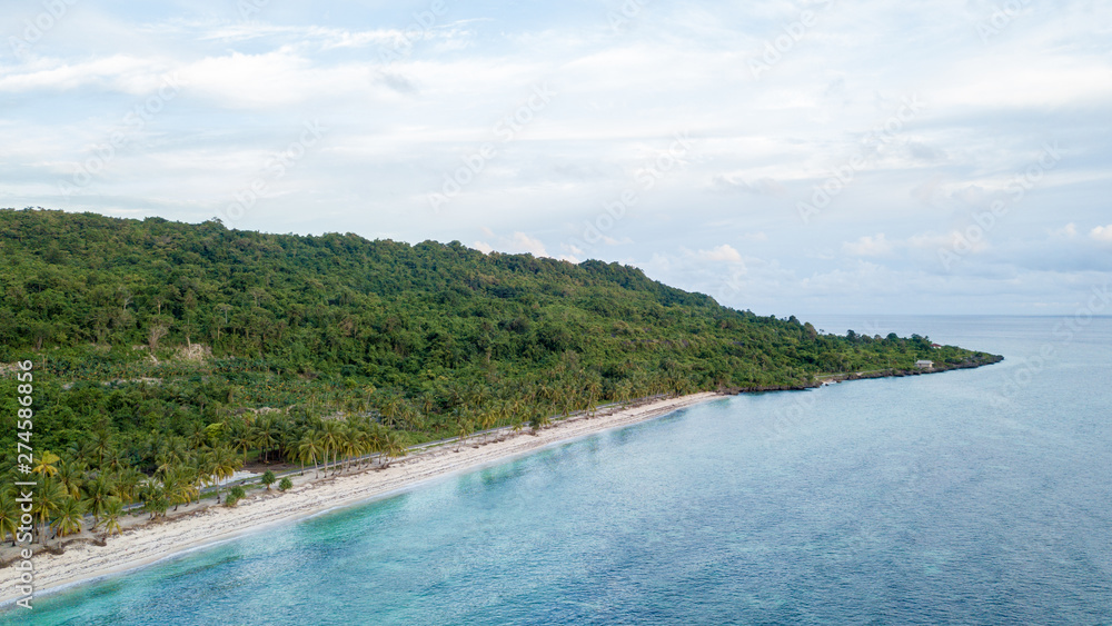 Aerial view of the beach and hills with nice sky and blue ocean in Wakatobi, Indonesia, Asia