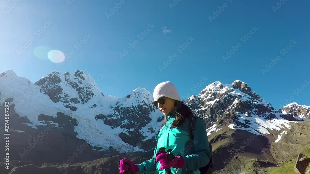 girl woman on a trail hiking in snow mountains in Cordillera Huayhuash Peru - South America