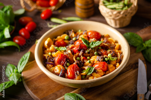 Corn paste with roasted tomatoes and fresh peas and onion