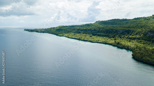 Bild auf Leinwand Aerial view of hill near beautiful blue ocean in Wakatobi, Indonesia, Asia