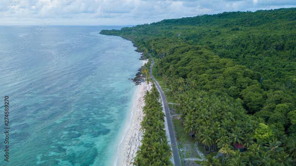 Aerial view of the beach near highway with nice sky and blue ocean in Wakatobi, Indonesia, Asia
