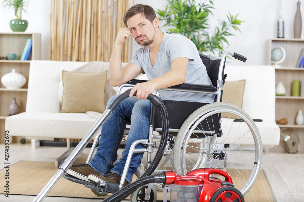 disabled man with vacuum cleaner at home disabled man with vacuum cleaner at home