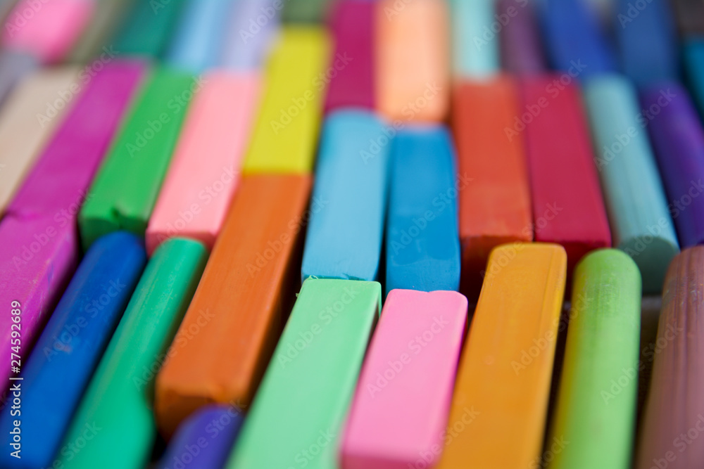 Blurred photo with chopsticks of multicolored art pastels suitable for the background. Symbol of creativity, joy, rich choice. Blurred photo with chopsticks of multicolored art pastels suitable for the background. Symbol of creativity, joy, rich choice.