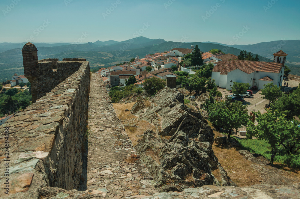 Old houses and church on top of ridge with stone wall in Marvao