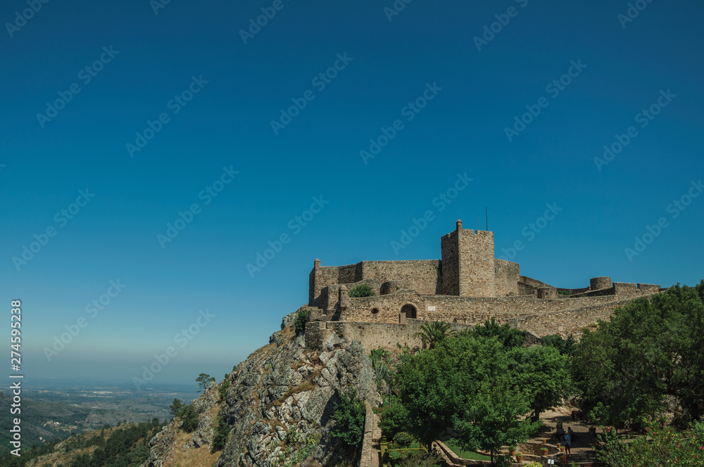 Stone walls and tower of Castle over hill near garden at Marvao