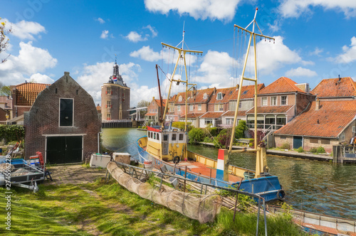Fishing boat in Enkhuizen in the Netherlands with the historic city gate (Drommedaris) in the background.. photo
